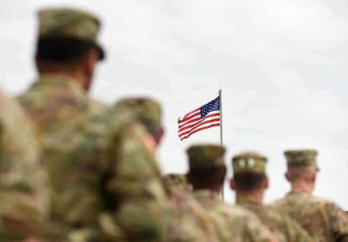 shutterstock_1170998920 U.S. flag flying above a formation of soldiers in uniform