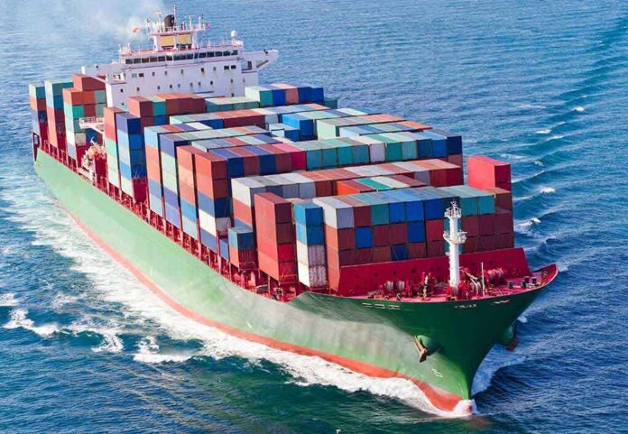 shutterstock_230506738 A large cargo ship loaded with colorful containers sailing on the ocean