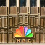 NBC peacock logo on building facade