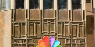 NBC peacock logo on building facade