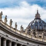 St. Peter's Basilica dome with statues along colonnade