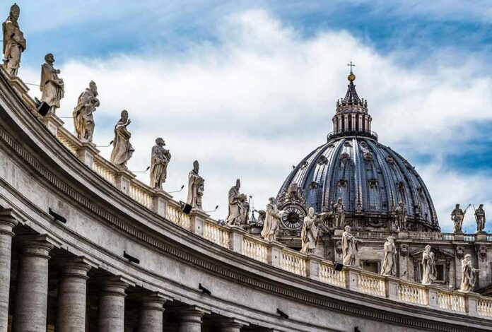 St. Peter's Basilica dome with statues along colonnade