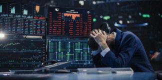 Trader stressed out by multiple declining stock charts.