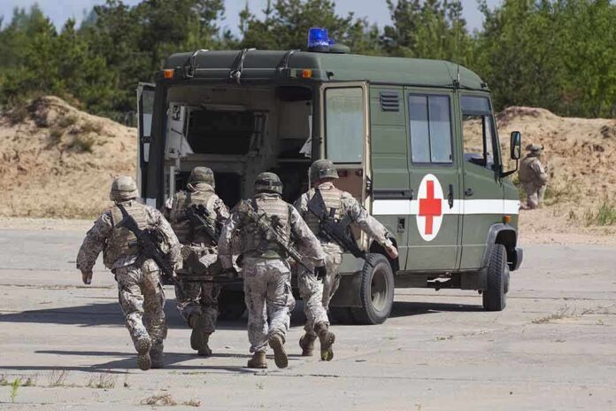 Soldiers running towards a medical vehicle during a military operation