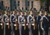 Group of uniformed cadets marching with rifles; named individuals: Zach Zenner, Griff Whalen, Patrick DiMarco, Freddie Williams II, Daryl Smith, Timmy Jernigan, Walter Jones