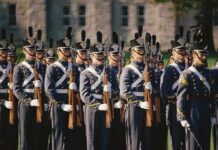 Tenure Freeze Rattles Military Classrooms Group of uniformed cadets marching with rifles; named individuals: Zach Zenner, Griff Whalen, Patrick DiMarco, Freddie Williams II, Daryl Smith, Timmy Jernigan, Walter Jones