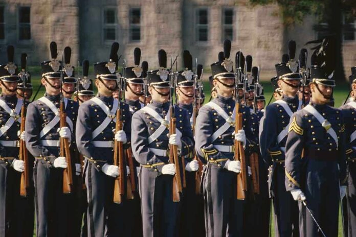 Group of uniformed cadets marching with rifles; named individuals: Zach Zenner, Griff Whalen, Patrick DiMarco, Freddie Williams II, Daryl Smith, Timmy Jernigan, Walter Jones