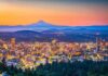 City skyline at dusk with mountain in the distance