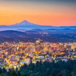 City skyline at dusk with mountain in the distance