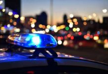 Fairground Frenzy: Crowd Injured, Suspect Down Police car light bar flashing at dusk