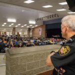 security officer overseeing a crowded school cafeteria