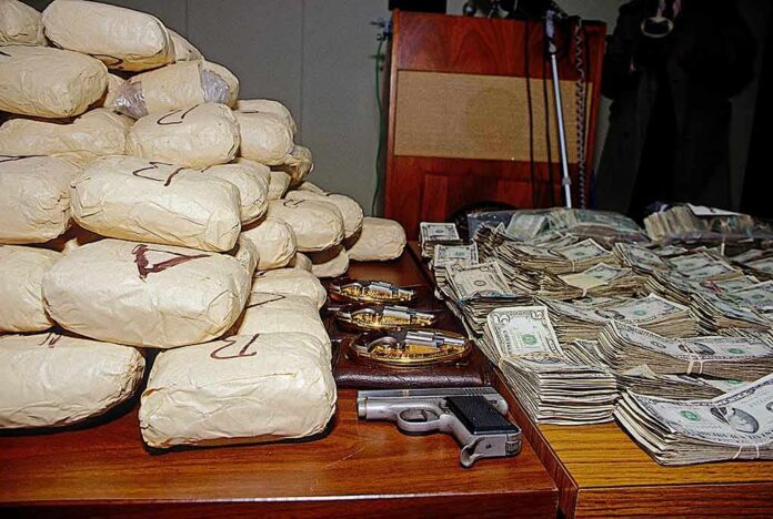 Seized packages, cash, and handguns on a table
