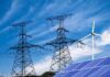 Power lines with wind turbine and solar panels