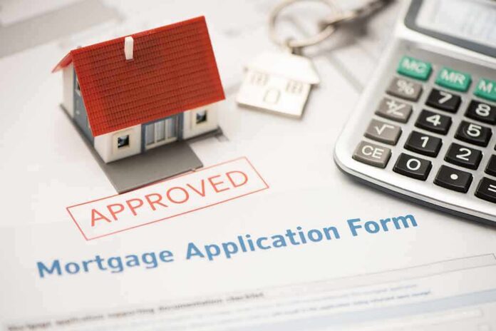 shutterstock_1397767763 Mortgage application form with approved stamp, model house, and calculator