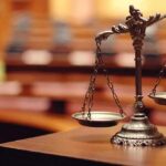 bronze balance scales on a courtroom desk