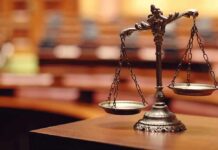 bronze balance scales on a courtroom desk