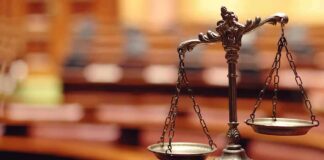 bronze balance scales on a courtroom desk