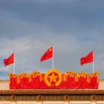 China Aids Iran? Troops Caught in Crosshairs Chinese flags atop a decorated building facade