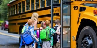 Children boarding a yellow school bus
