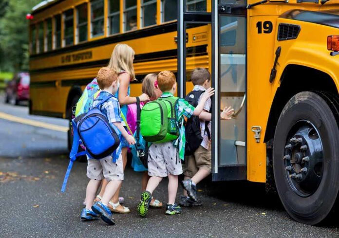 Children boarding a yellow school bus