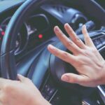 Privilege Play? Police Skip The Test Driver pressing car horn on steering wheel