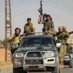 Congressman Describes Armed West Bank Standoff armed men riding on pickup trucks in a convoy