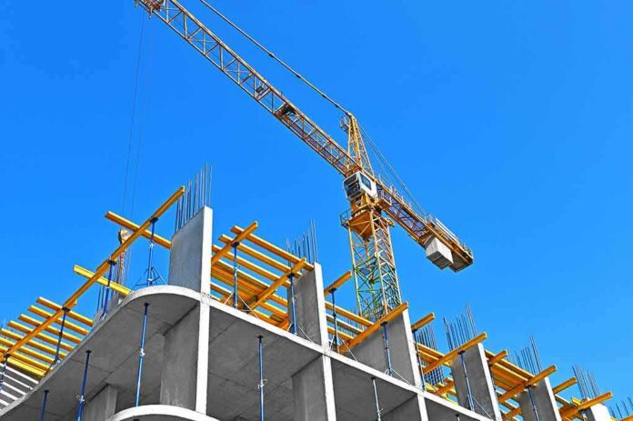 Tower crane over concrete building under construction