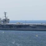 Emergency Sea Hawk Landing Draws Attention Aircraft carrier sailing at sea