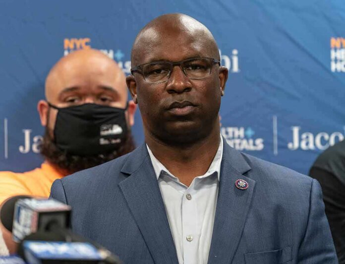 Man in suit and glasses at a press conference