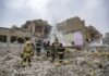 Firefighters search rubble of a partially collapsed building