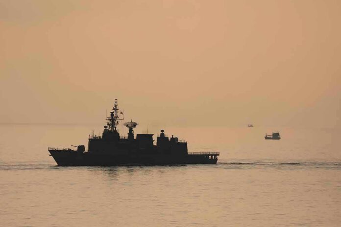 shutterstock_2187790935 naval ship silhouette at sea during sunset