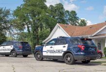 Horror Basement Scene Shocks Suburb Two police SUVs parked near a suburban house