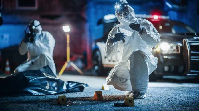forensic investigators at nighttime crime scene