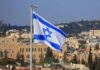 Israeli flag waving over a cityscape