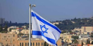 Israeli flag waving over a cityscape