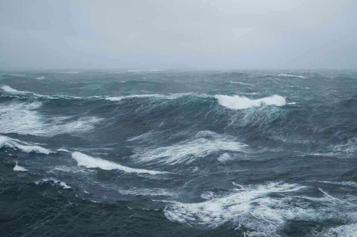 Rough ocean waves under a cloudy sky