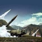 mobile missile launcher firing in mountain landscape