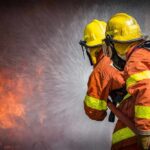 Firefighters spraying water on a blaze