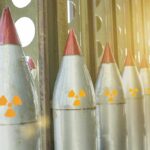 Row of missiles with radiation symbols in storage rack