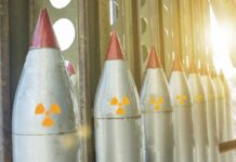 Row of missiles with radiation symbols in storage rack