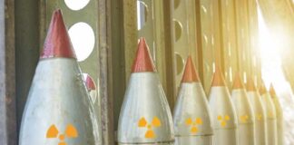 Row of missiles with radiation symbols in storage rack