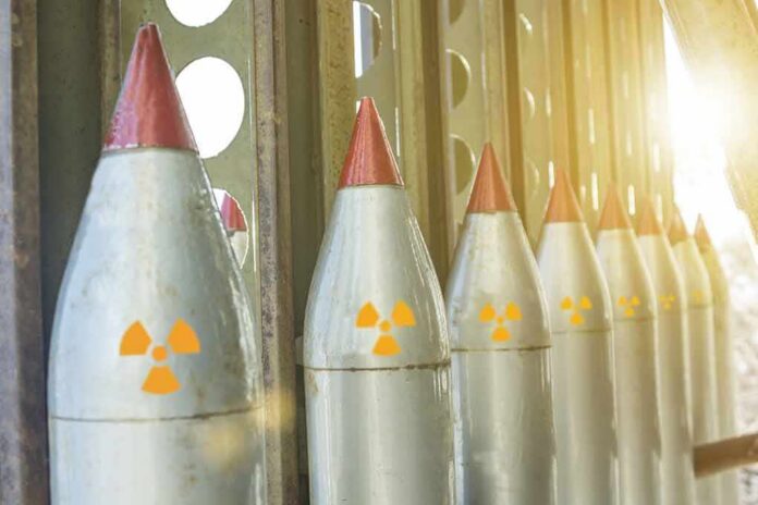 Row of missiles with radiation symbols in storage rack