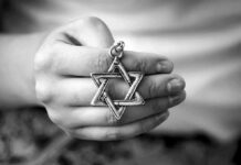 Hand holding a Star of David pendant