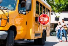 A Federal Probe Is Digging Into School Misconduct School bus with extended stop sign near students on sidewalk