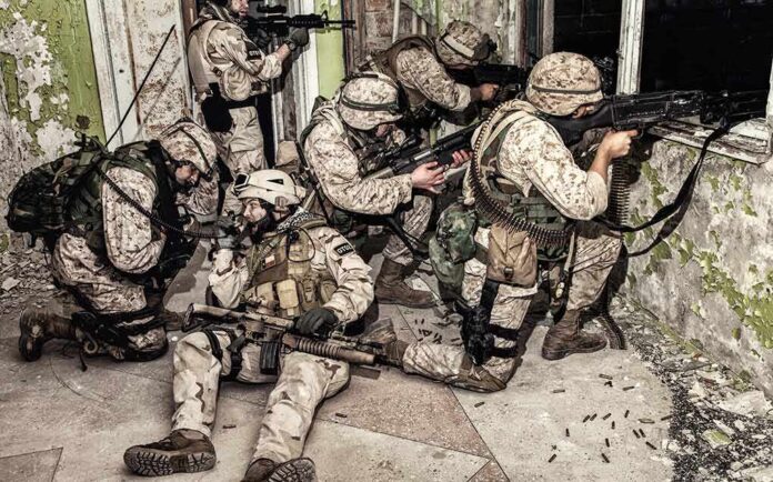 shutterstock_1163417059 soldiers in camouflage gear take positions inside a damaged building