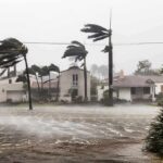 Houses battered by hurricane winds and flooding