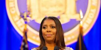 Woman speaking at podium with microphones