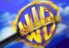 Warner Bros. shield logo under a magnifying glass