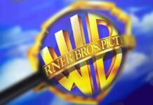 Warner Bros. shield logo under a magnifying glass