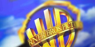 Warner Bros. shield logo under a magnifying glass